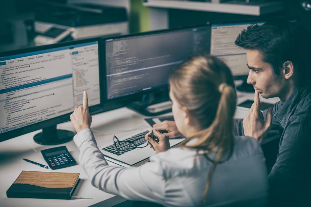 Une developpeuse web montre son travail à un collaborateur